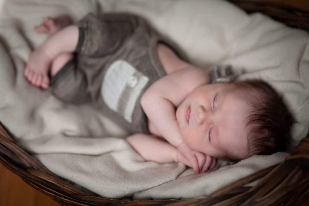 newborn snuggled in basket