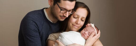 mother and father holding baby