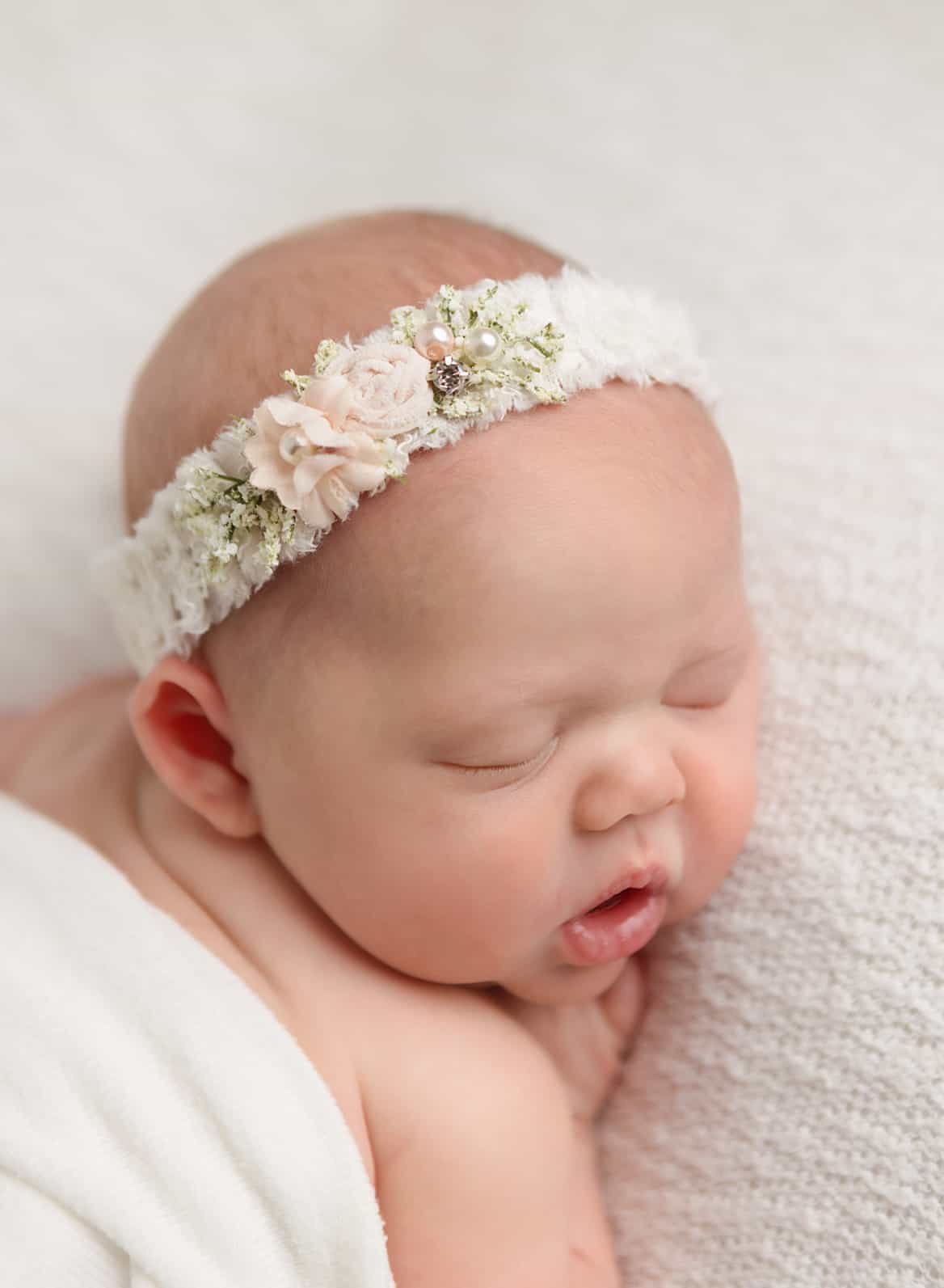 Newborn close up in floral headband