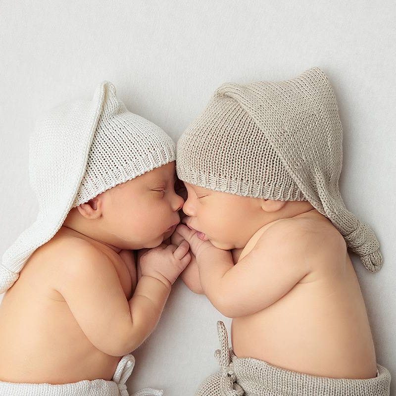 Windham NH Twin Newborn Session - Twin boys face to face holding hands.