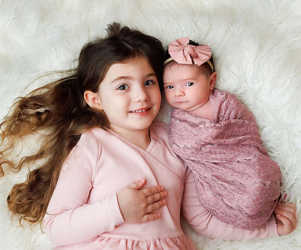 Derry NH Newborn portrait of sister holding baby sister.