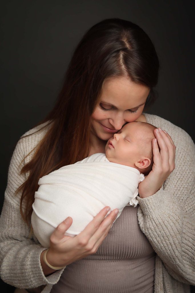 Boston Newborn Portrait of mother holding newborn daughter in an ivory wrap.