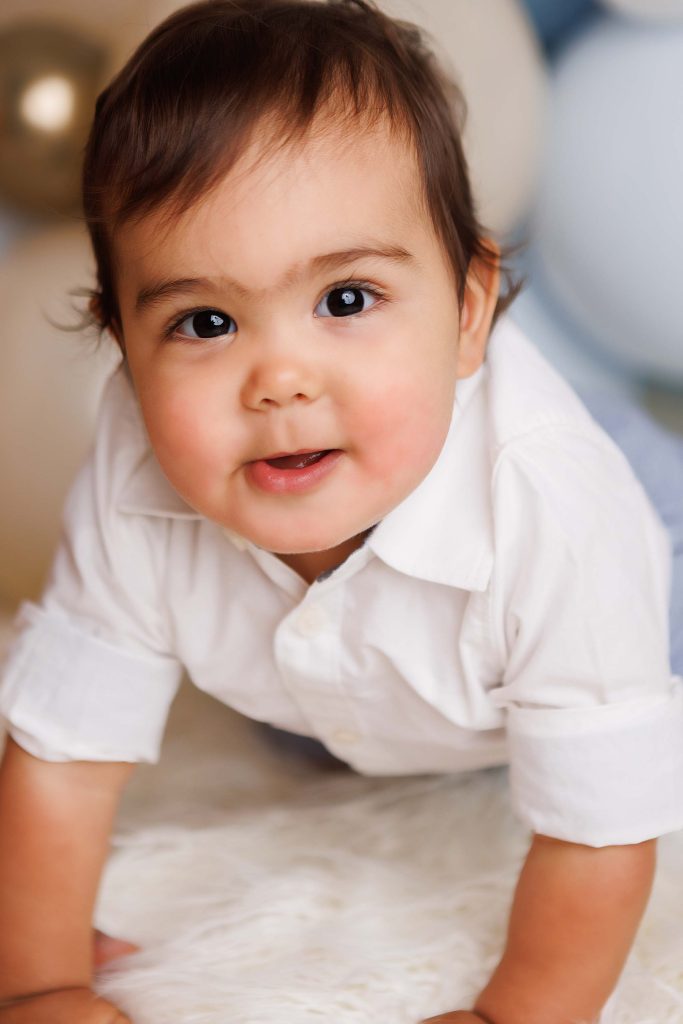 Close up of little boy crawling towards camera.