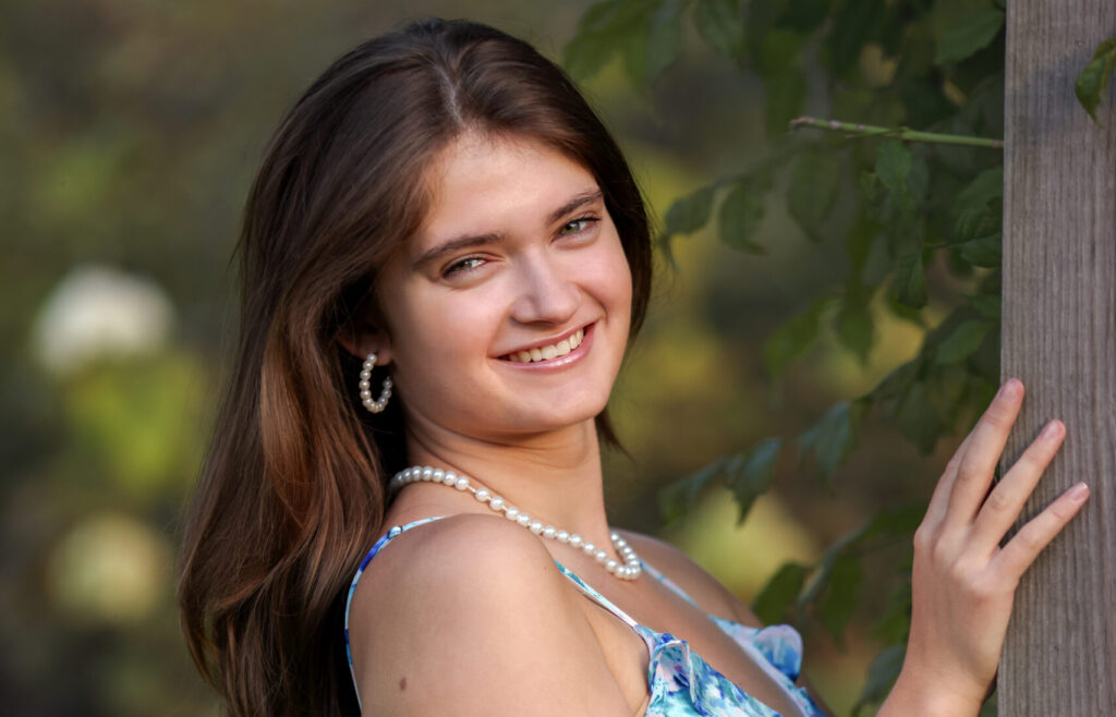 Windham Senior Posing for senior portrait. Wearing a summer dress.