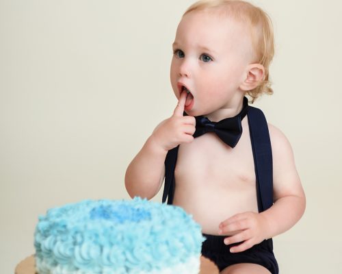 Windham NH One Year old eating cake during his cake smash session.