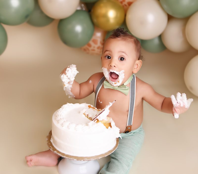 Messy NH Cake Smash Session of little boy all covered in frosting.
