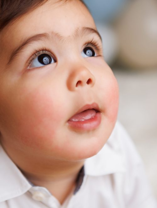 One year portrait of little boy looking up. Close up of his face.